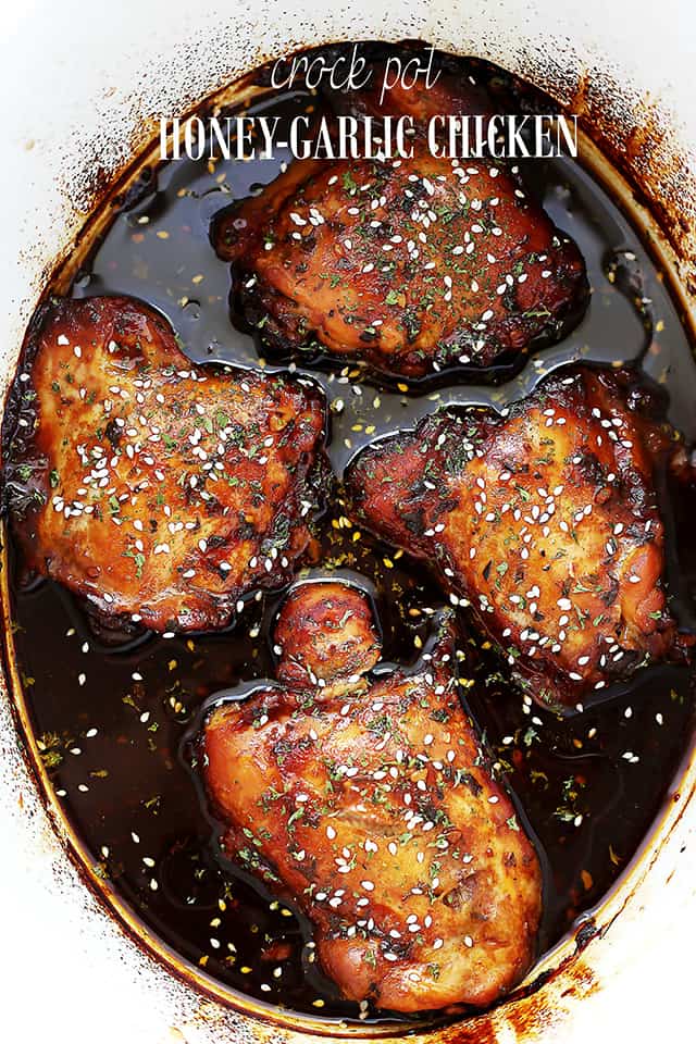 Chicken thighs cooked in a sweet brown sauce, sprinkled with sesame seeds.