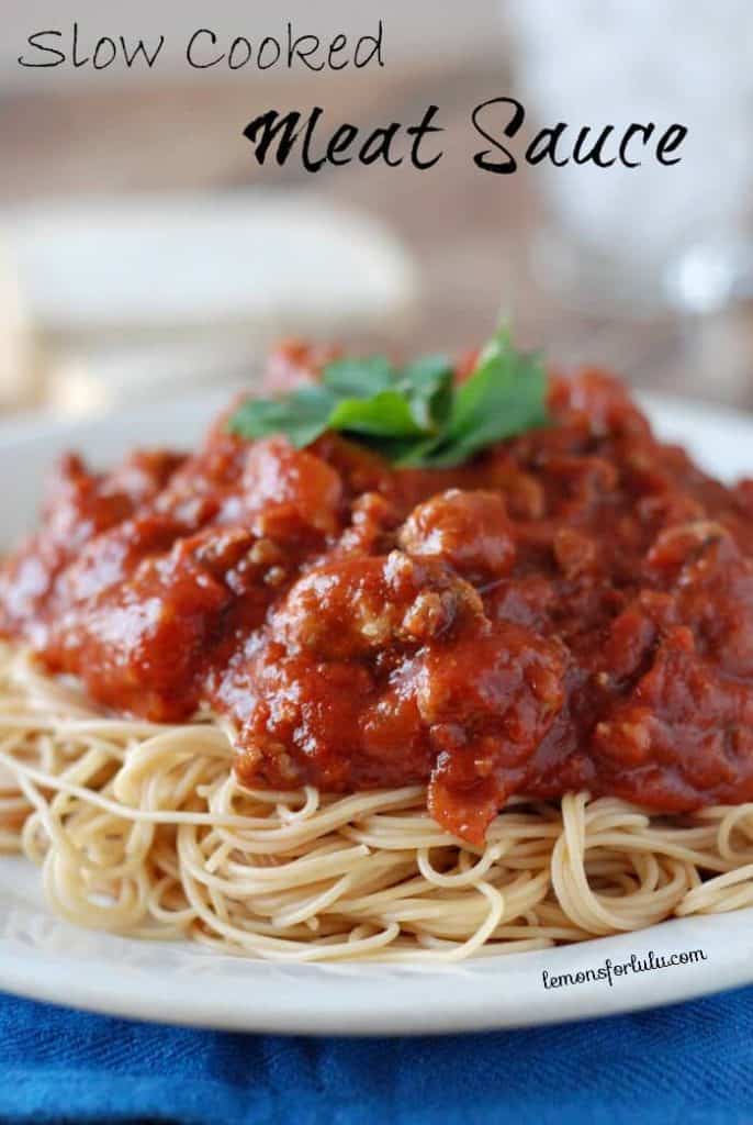 Slow cooker meat sauce over spaghetti on a plate