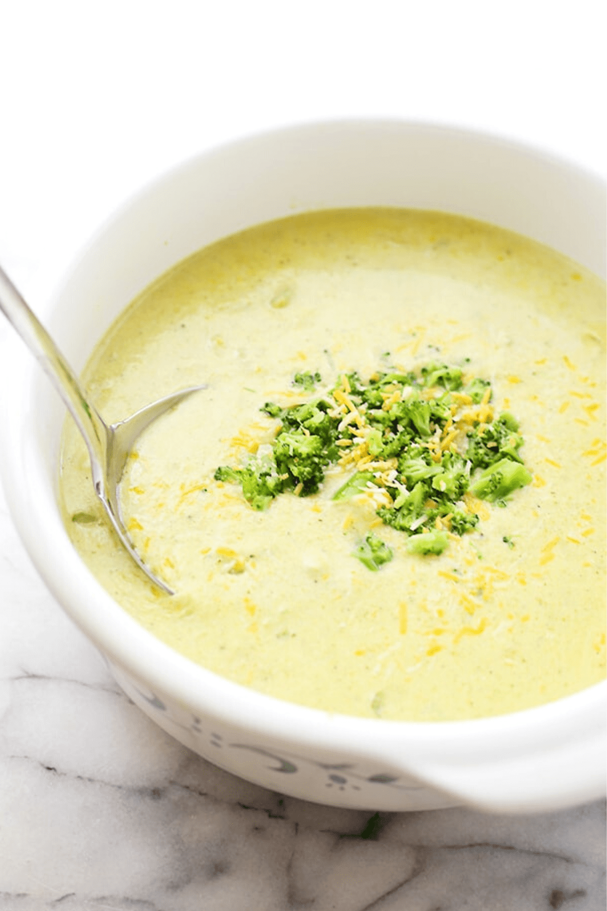 white dutch oven filled with Broccoli Cheese Soup