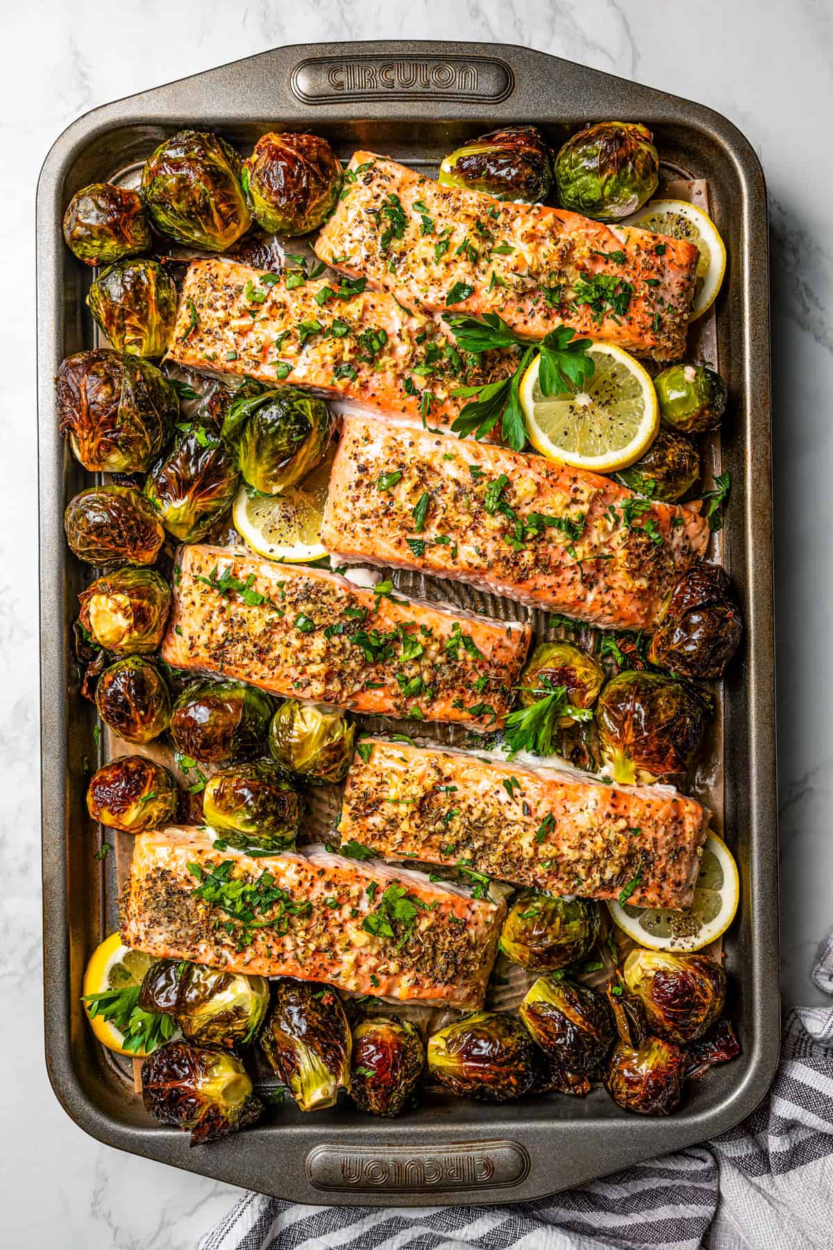 Overhead view of sheet pan salmon with roasted Brussels sprouts.