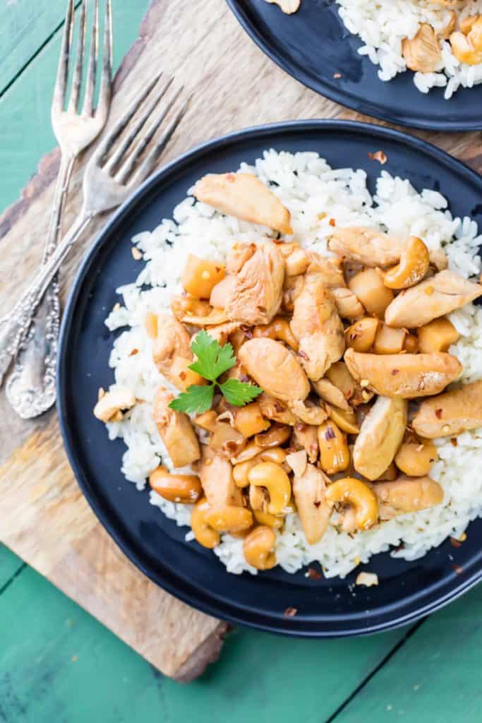 Slow cooker cashew chicken over rice in a bowl