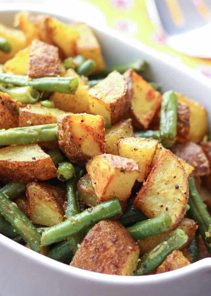 Turmeric roasted potatoes and green beans in a serving bowl