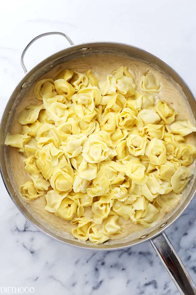 Rosemary Garlic Tortellini Alfredo - Easy, creamy, garlicky, 30-minute dinner with cheese tortellini and a lightened-up, homemade, flavorful Alfredo sauce.