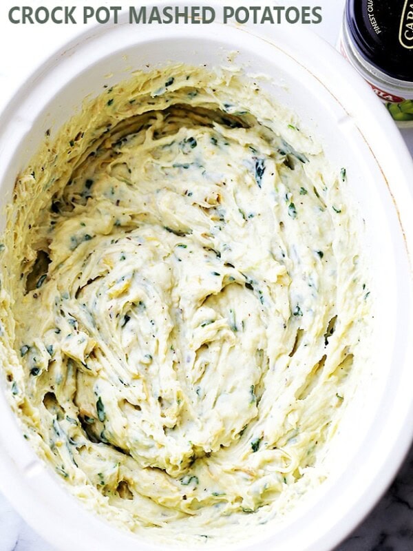 Spinach and Artichoke Dip Crock Pot Mashed Potatoes - Easy to make crock pot Mashed Potatoes with everyone's favorite spinach and artichoke dip cooked right in it!