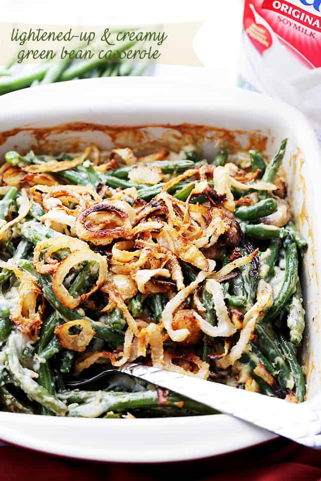 Lightened-up creamy green bean casserole is served from a baking dish.
