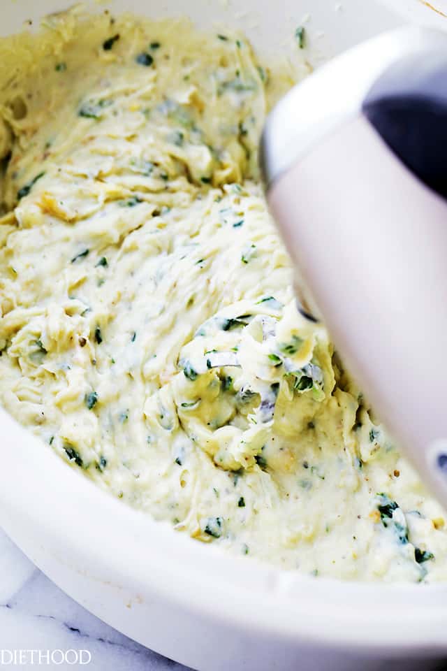 Spinach and Artichoke Dip Crock Pot Mashed Potatoes - Easy to make crock pot Mashed Potatoes with everyone's favorite spinach and artichoke dip cooked right in it!