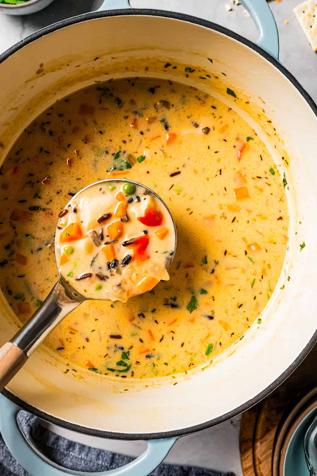Weekly Menu Plan Photo of a ladle spooning out crab soup from a large pot.