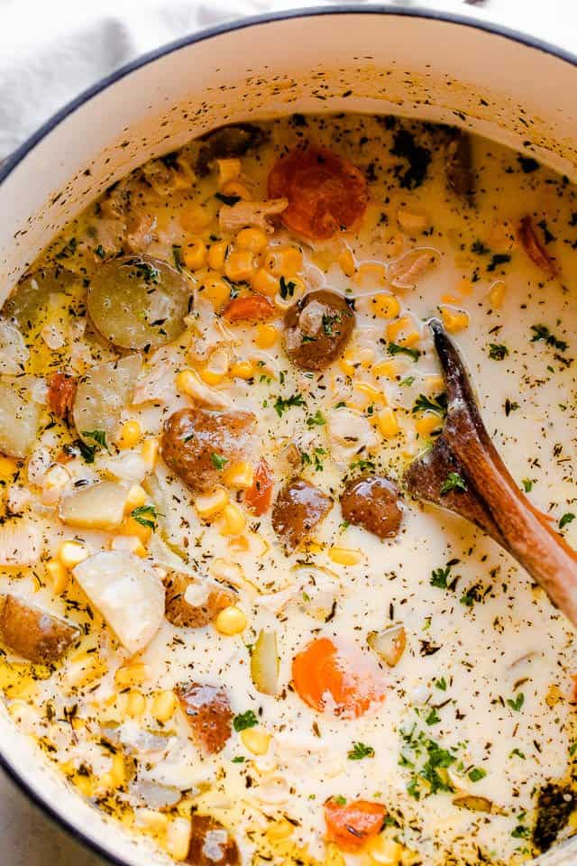 overhead shot of a dutch oven with chowder with leftover turkey, potatoes, and corn