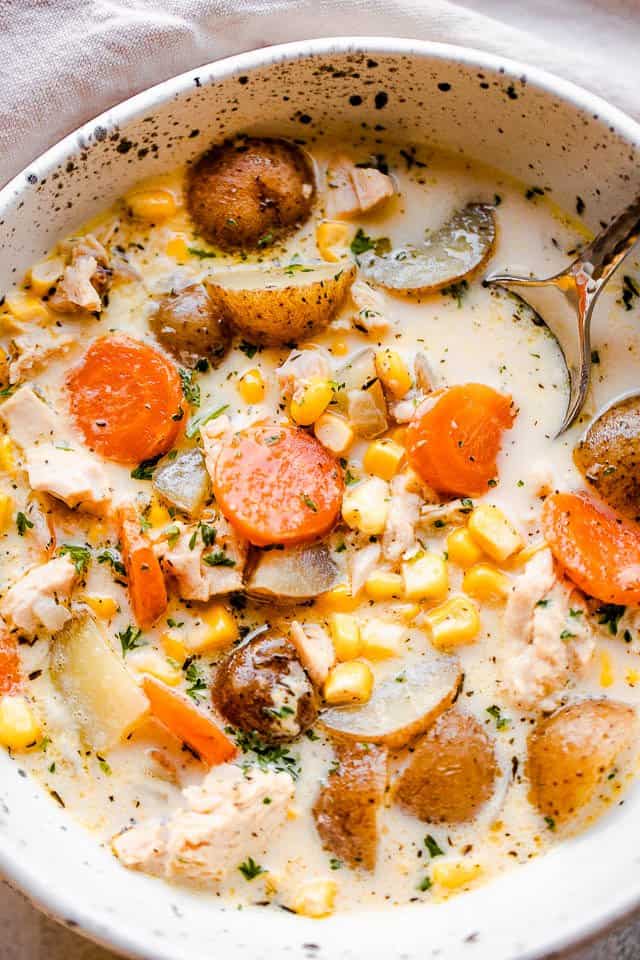 overhead shot of a soup bowl filled with chowder with leftover turkey, potatoes, and corn