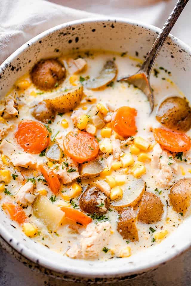 overhead shot of a soup bowl filled with chowder with leftover turkey, potatoes, and corn