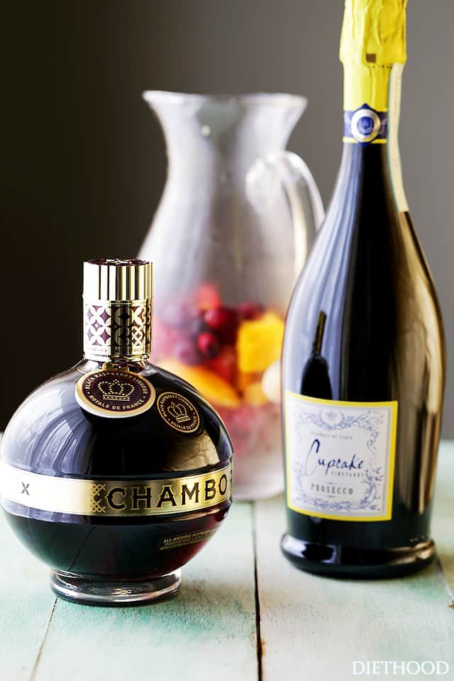 Bottles of Prosecco and Chambord Liqueur are set on a table.