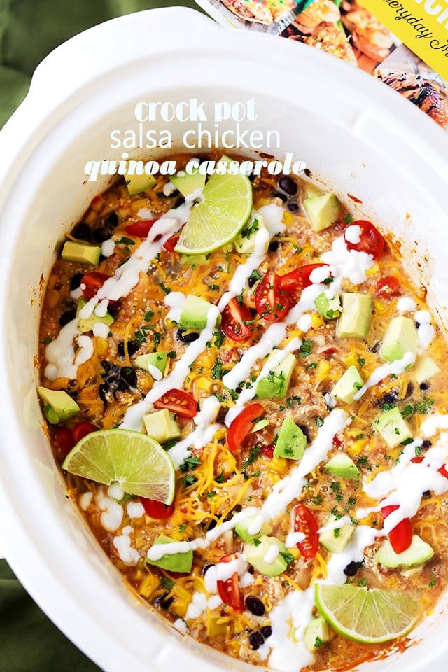 Crock Pot Salsa Chicken Quinoa Casserole topped with sour cream and lime wedges.