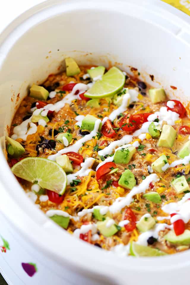 Crock Pot Salsa Chicken Quinoa Casserole Recipe - Give rotisserie chicken new life with this super simple and delicious casserole. Packed with quinoa, chicken, veggies, and salsa, this is about to become your new go-to hearty meal! All you need to do is arrange the ingredients in the crock pot and walk away.