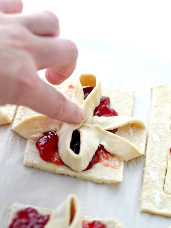 Raspberry Jam Filled Puff Pastries - A super easy holiday pastry filled with raspberry jam, and shaped into edible Christmas gifts!