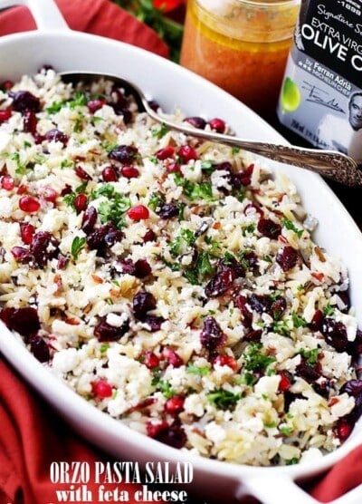 Orzo Pasta Salad with Feta Cheese and Cranberry Pomegranate Vinaigrette Recipe - This cheesy orzo pasta salad is full of bright and colorful winter flavors tossed with a delicious dose of Cranberry Pomegranate Vinaigrette. It's also the perfect side dish to share at your next Holiday gathering!