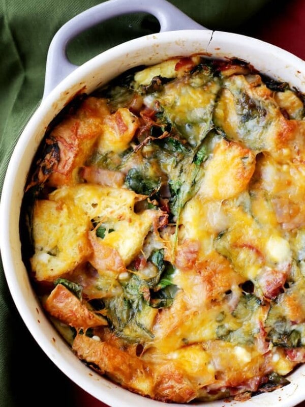 Make ahead breakfast casserole topped with broiled cheese in a white baking dish.