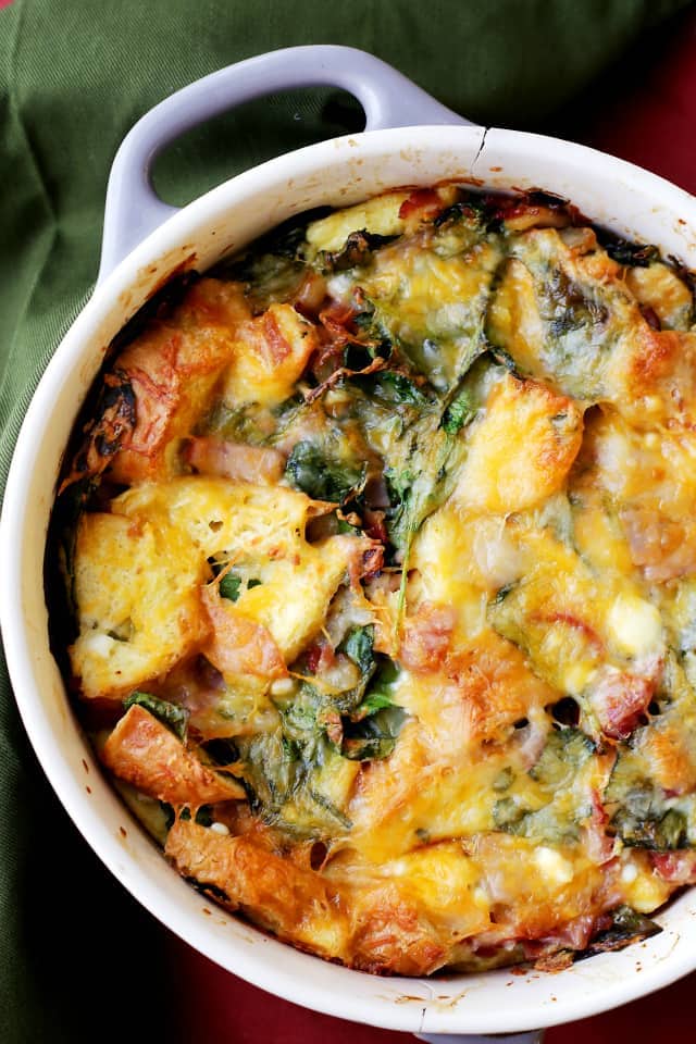 Make Ahead Breakfast Casserole - Easy to prepare, make ahead breakfast casserole chock full of hearty bacon, ham, cheeses and spinach. Prepare this the night before and just pop it in the oven in the morning. Warm, cheesy and delicious!