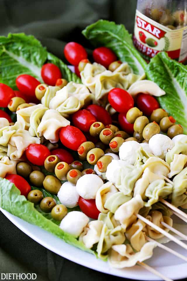 Tortellini Skewers with Olives Tomatoes and Cheese Recipe - Fun and festive appetizer plate with cheesy tortellini, flavorful manzanilla olives, grape tomatoes and fresh mozzarella cheese threaded on skewers. A gorgeous addition to your Holiday table!