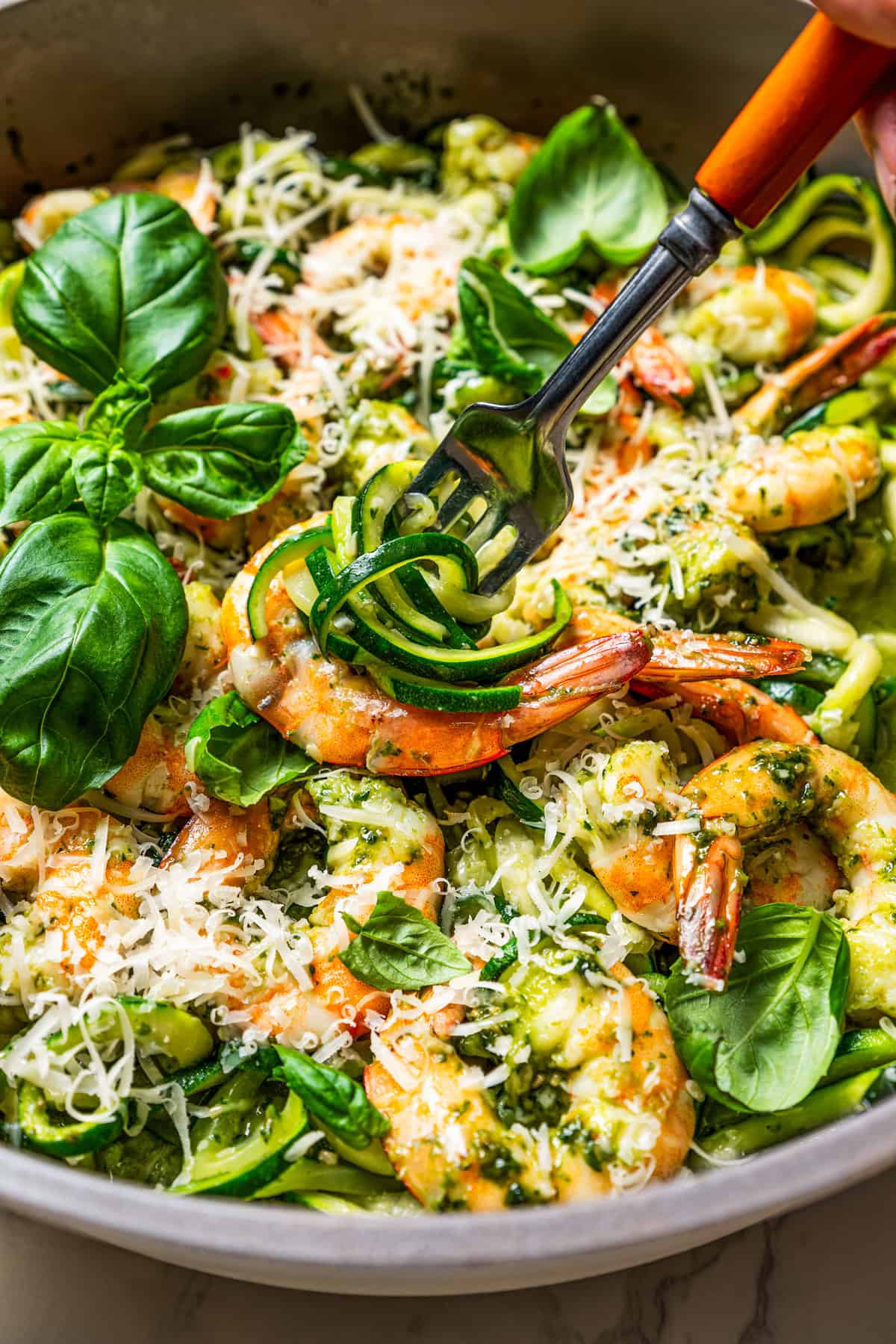 A fork twirling a bite of zucchini noodles.