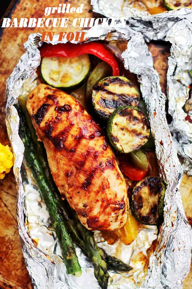 Grilled Barbecue Chicken and Vegetables in Foil - Tender, flavorful chicken covered in sweet barbecue sauce and cooked on the grill inside foil packs with zucchini, bell peppers and asparagus.