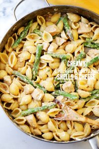 Pasta shells with chicken, asparagus, and feta cheese.