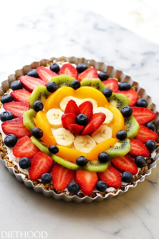 Fruit Pizza in a tart pan featuring a blend of berries, kiwi, bananas, and peaches.