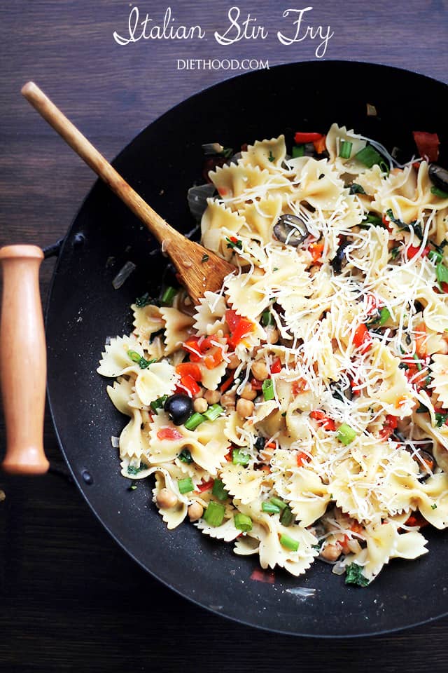 Pasta and vegetables cooking in a wok.