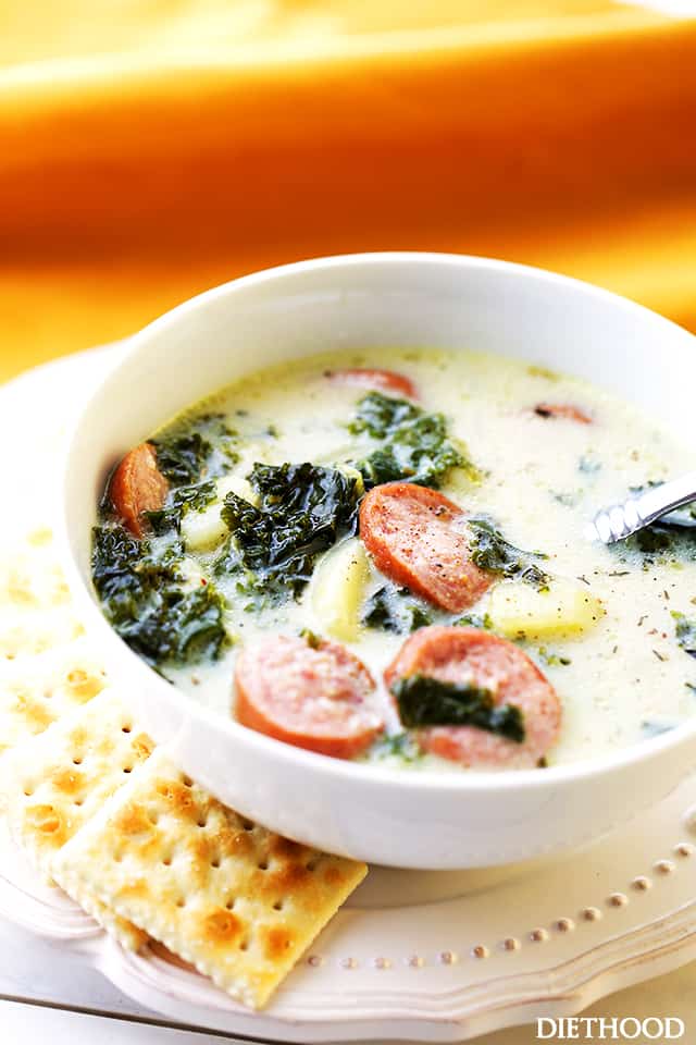 Smoked Sausage, Kale and Potato Soup in a bowl with crackers.