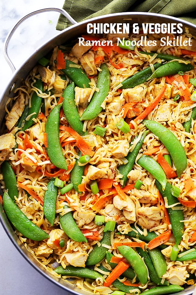 Chicken ramen noodles with snap peas and carrots in the skillet. 