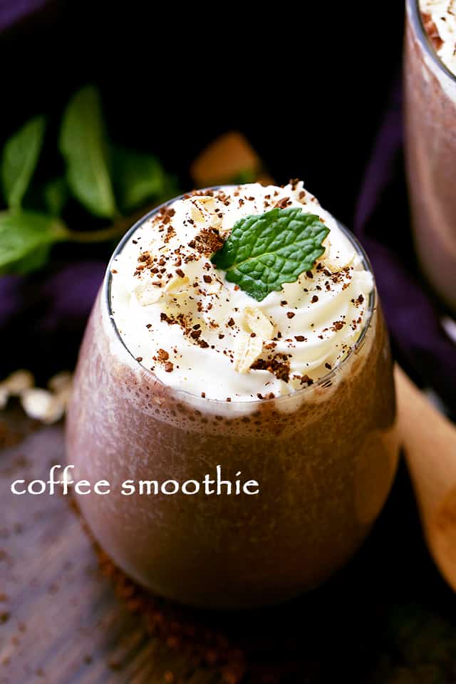 Coffee Smoothie in a glass and topped with whipped cream plus a mint leaf.