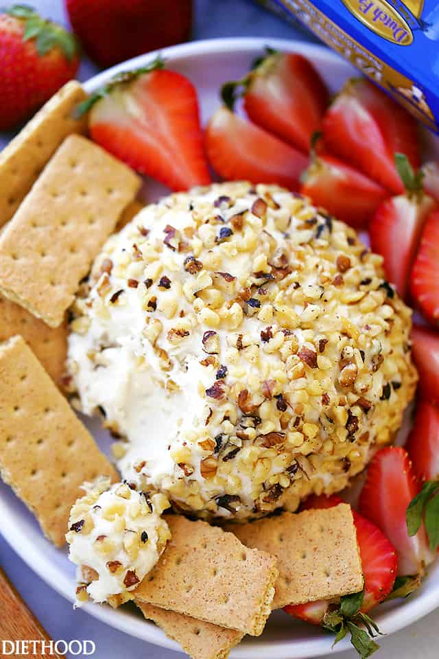 Overhead view of White Chocolate Cheeseball with graham crackers and strawberries on a plate