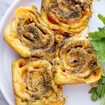 Pesto Ham and Cheese Rollups Recipe - Quick, delicious, easy party food with refrigerated crescents dough, ham, cheese and basil pesto. You're only 4 ingredients away from your next favorite bite!