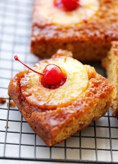 A square piece of Pineapple Upside Down Cake on a wire rack
