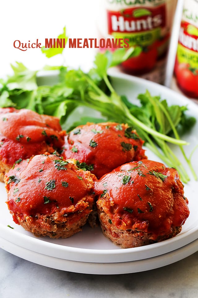 Four mini meatloaves on a white plate