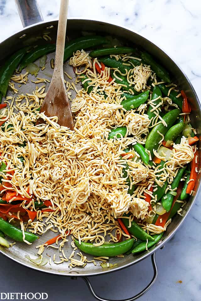 Mixing the noodles into the skillet. 