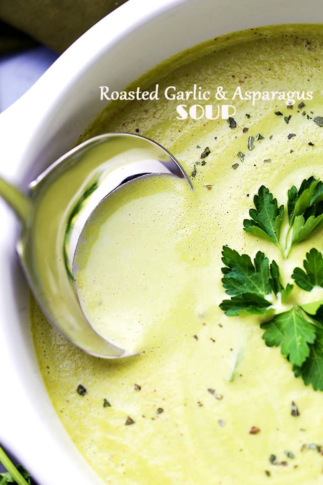 Roasted Garlic and Asparagus Soup in a pot with ladle.