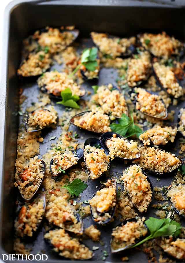 Roasted Mussels with Garlic-Butter Crumbs - These Mussels topped with garlic butter crumbs and roasted in the oven, serve perfectly as an appetizer, or over pasta for a delicious dinner.