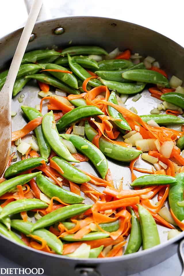 Cooking the veggies in the skillet. 