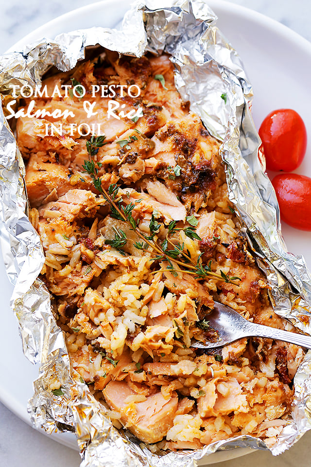 Tomato Pesto Salmon and Rice Recipe Baked in Foil - Incredibly flavorful, quick, 30-minute healthy dinner recipe with tomato pesto, salmon and rice baked in foil.