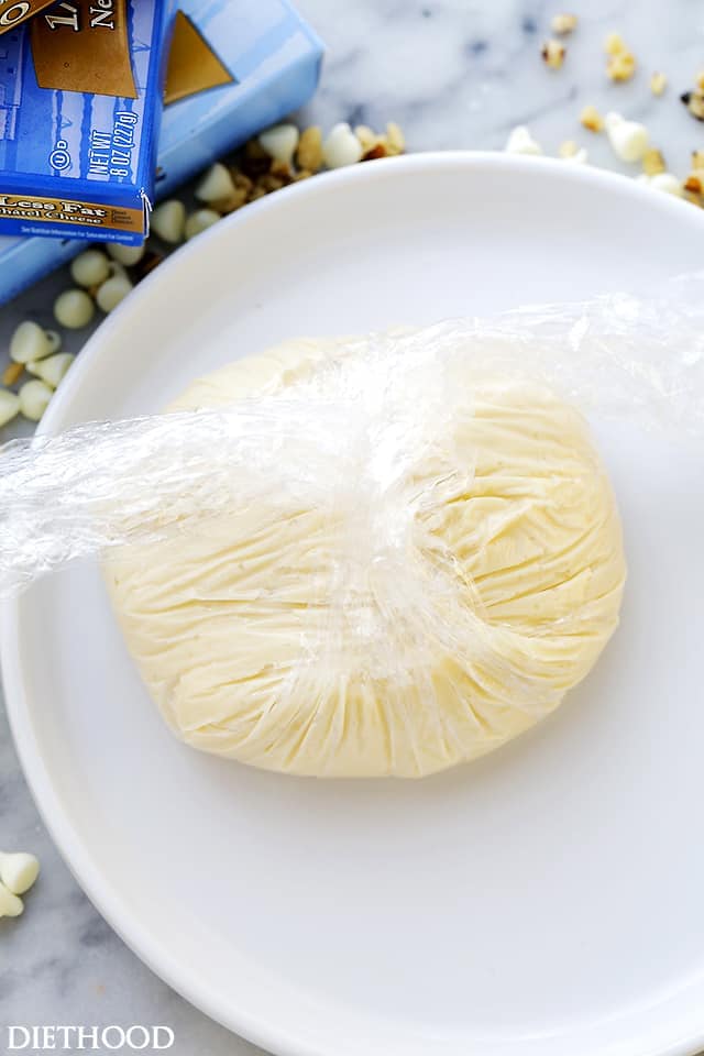 Overhead view of Cream Cheese White Chocolate Cheeseball filling wrapped in plastic wrap