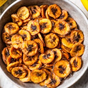 Baked banana chips in a bowl.