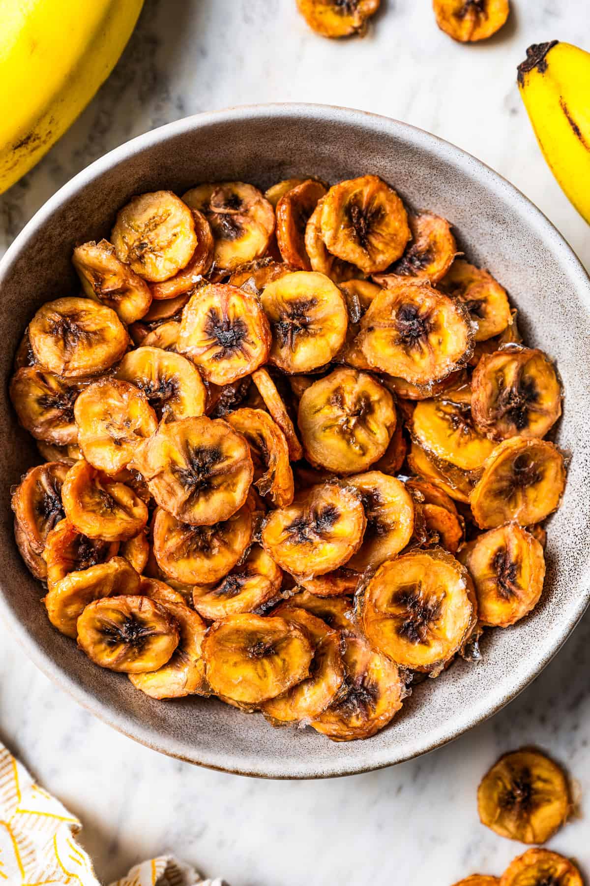 Baked banana chips in a bowl.