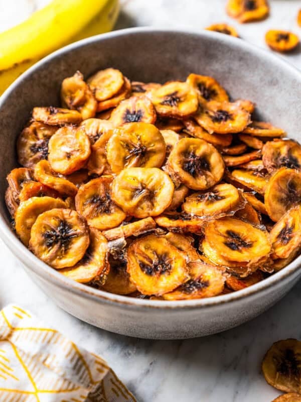 Banana chips in a grey stoneware bowl.