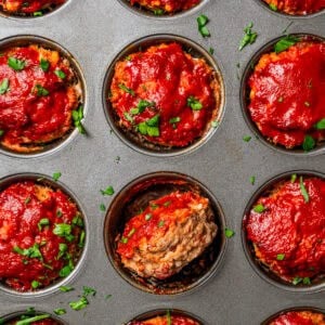 Baked mini meatloaf in a muffin pan.