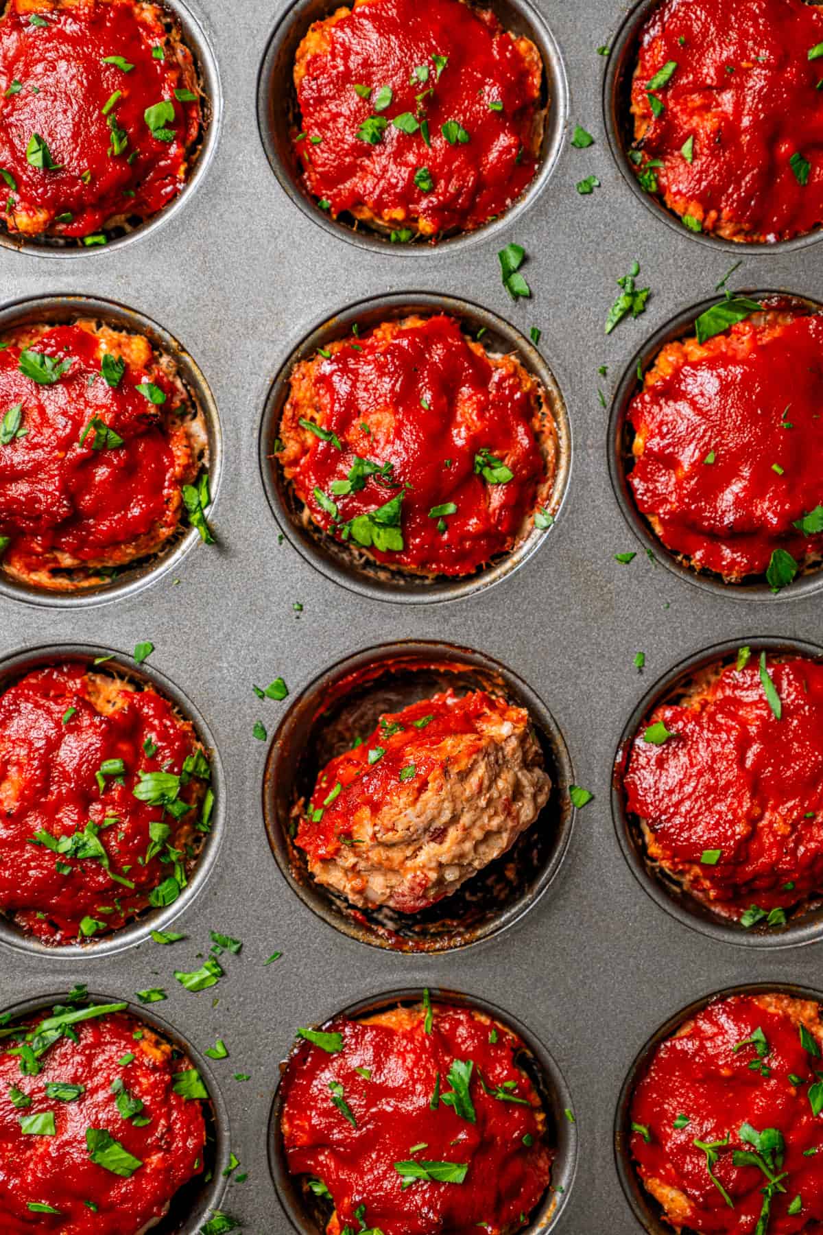 Baked mini meatloaf in a muffin pan.