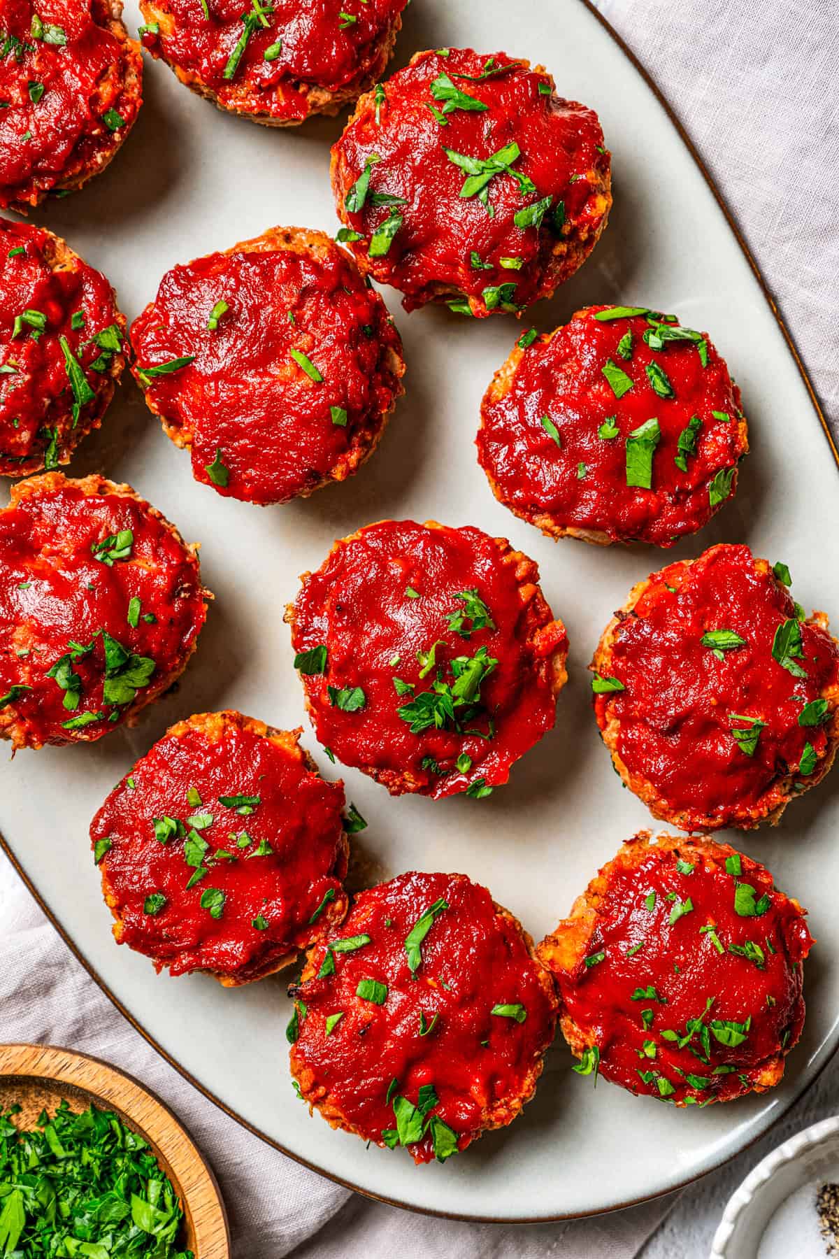 Mini turkey meatloaves arranged on an oval platter.