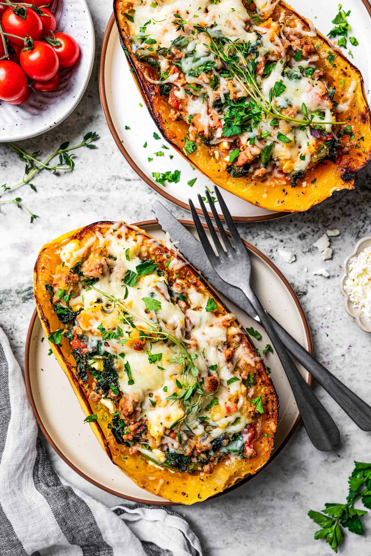 Two spaghetti squash boats served on dinner plates.