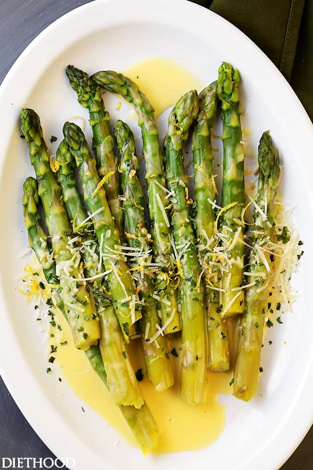 Asparagus with Lemon Butter Sauce - Budget friendly, quick, and easy crisp-tender asparagus drizzled with an amazing lemon butter sauce and a sprinkle of parmesan cheese. The BEST asparagus side dish of ever!