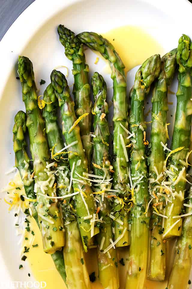 Close-up image of Asparagus spears drizzled with Lemon Butter Sauce.