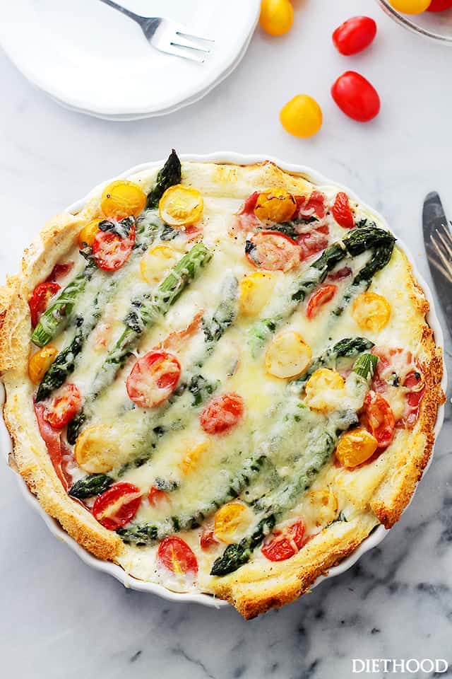 Overnight Breakfast Strata with Prosciutto and Asparagus - This delicious breakfast strata is loaded with prosciutto, tomatoes, and asparagus, and it's the best way to serve breakfast or brunch to a crowd.